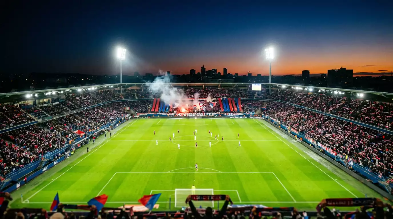 Estadio de fútbol francés iluminado durante un partido nocturno de la Ligue 1